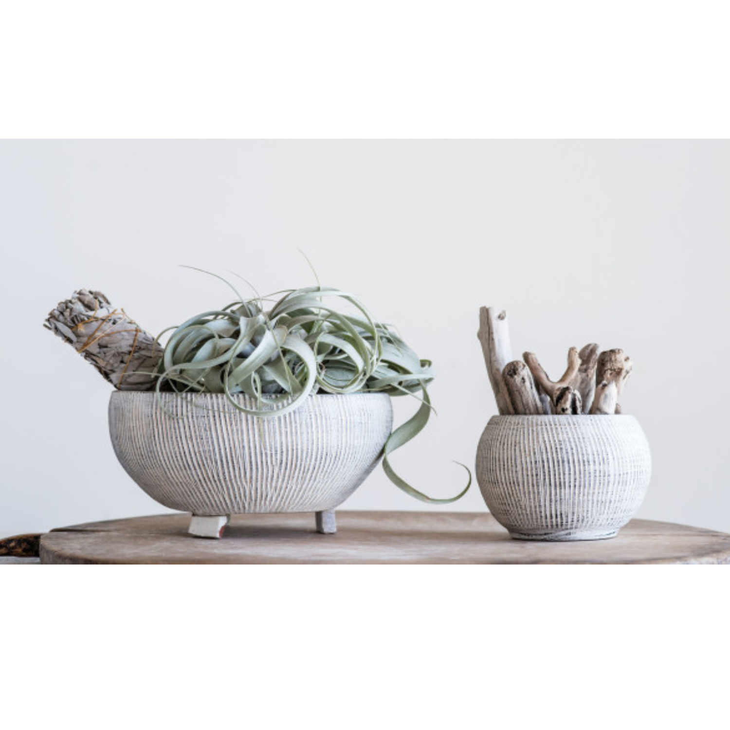 A distressed cream terracotta planter with fluted texture